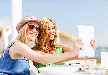 Image showing girls taking photo in cafe on the beach