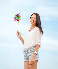 Image showing girl with windmill toy on the beach