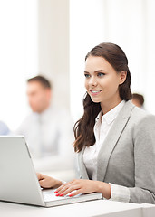 Image showing businesswoman with laptop computer at work