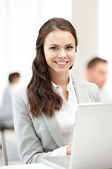 Image showing businesswoman with laptop computer at work