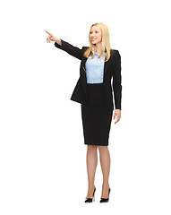 Image showing attractive businesswoman pointing at something