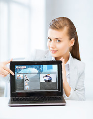 Image showing woman showing laptop pc with news