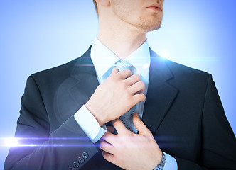 Image showing man adjusting his tie