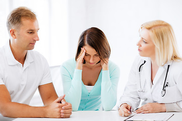 Image showing doctor with patients in cabinet