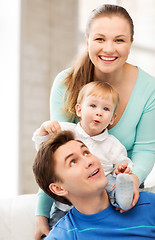 Image showing happy parents playing with adorable baby