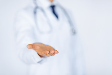 Image showing male doctor holding something in his hand