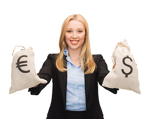 Image showing businesswoman holding money bags with euro