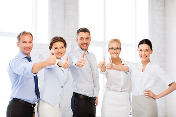 Image showing business team showing thumbs up in office