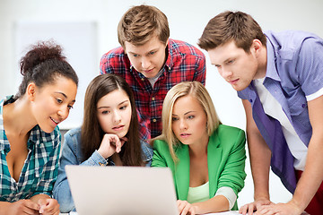 Image showing international students looking at laptop at school