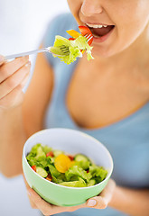 Image showing woman eating salad with vegetables