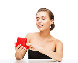 Image showing woman with diamond earrings and gift box