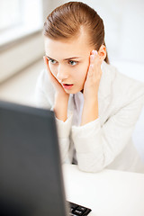 Image showing stressed businesswoman with computer