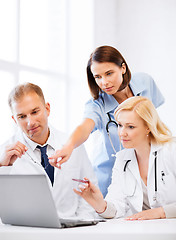 Image showing doctors looking at laptop on meeting