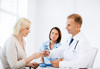 Image showing doctor giving tablets to patient in hospital