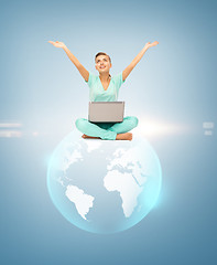 Image showing woman with laptop and sphere globe