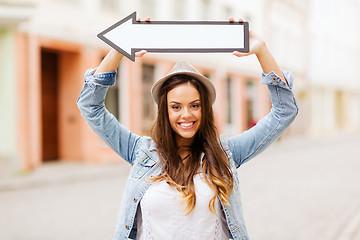 Image showing girl showing direction with arrow in the city