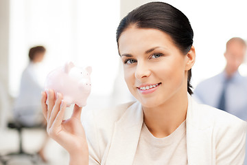 Image showing woman with piggy bank