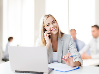 Image showing businesswoman with phone in office