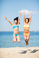 Image showing girls jumping on the beach