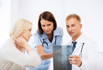 Image showing doctors with patient looking at x-ray