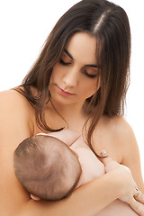 Image showing happy mother feeding her adorable baby