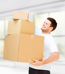 Image showing young man carrying carton boxes