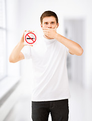 Image showing young man holding no smoking sign