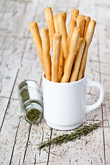 Image showing cup with bread sticks grissini and rosemary