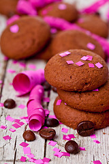 Image showing fresh chocolate cookies, coffee beans, pink ribbons and confetti