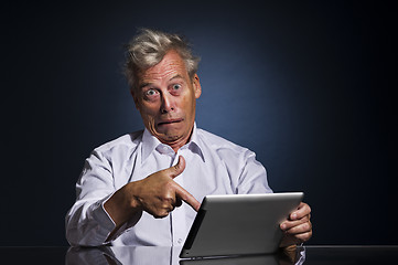 Image showing Man pointing to his laptop in horror and disbelief