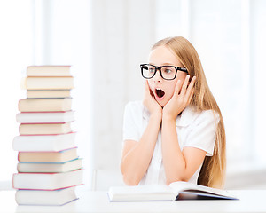 Image showing girl with many books at school