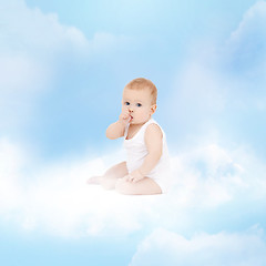 Image showing smiling baby sitting on the cloud