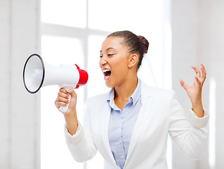 Image showing strict businesswoman shouting in megaphone