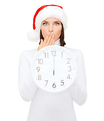 Image showing woman in santa helper hat with clock showing 12