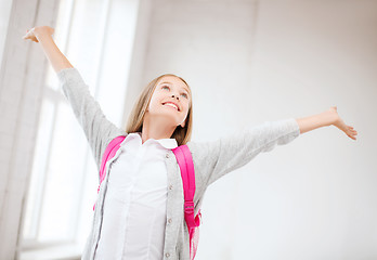 Image showing happy teenage girl with raised hands
