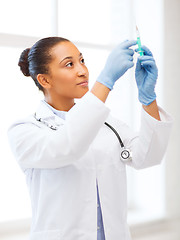 Image showing african doctor holding syringe with injection