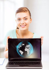 Image showing woman with laptop and sphere globe