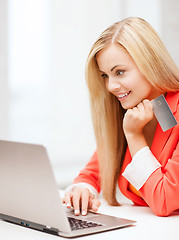 Image showing businesswoman with laptop using credit card