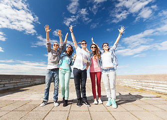 Image showing group of teenagers holding hands up
