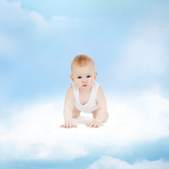 Image showing smiling baby sitting on the cloud