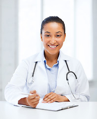 Image showing female doctor writing prescription