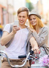 Image showing couple with bicycles in the city