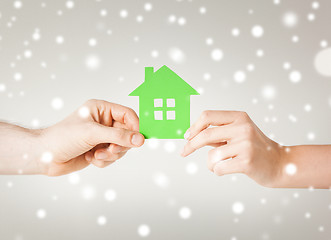 Image showing couple hands holding green house