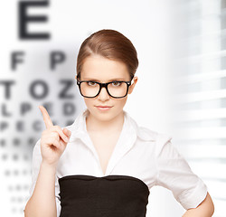 Image showing woman in eyeglasses with eye chart