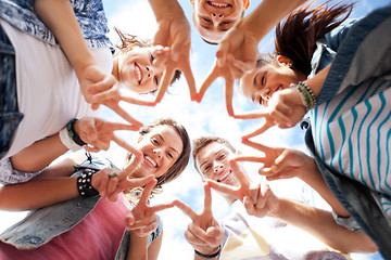 Image showing group of teenagers showing finger five