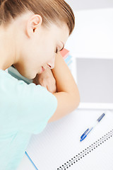 Image showing tired student sleeping on stock of books