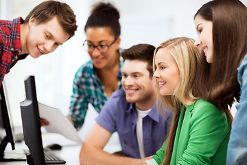 Image showing students looking at computer monitor at school