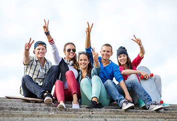 Image showing group of teenagers showing finger five