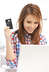 Image showing happy teenage girl with laptop and credit card
