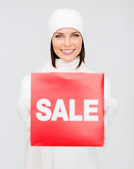 Image showing woman in winter clothes with red sale sign